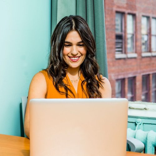 girl at computer getting results as a social media manager